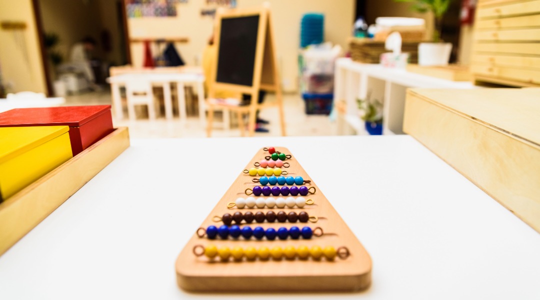 A picture of a Montessori elementary classroom, which is much different than a traditional school classroom.