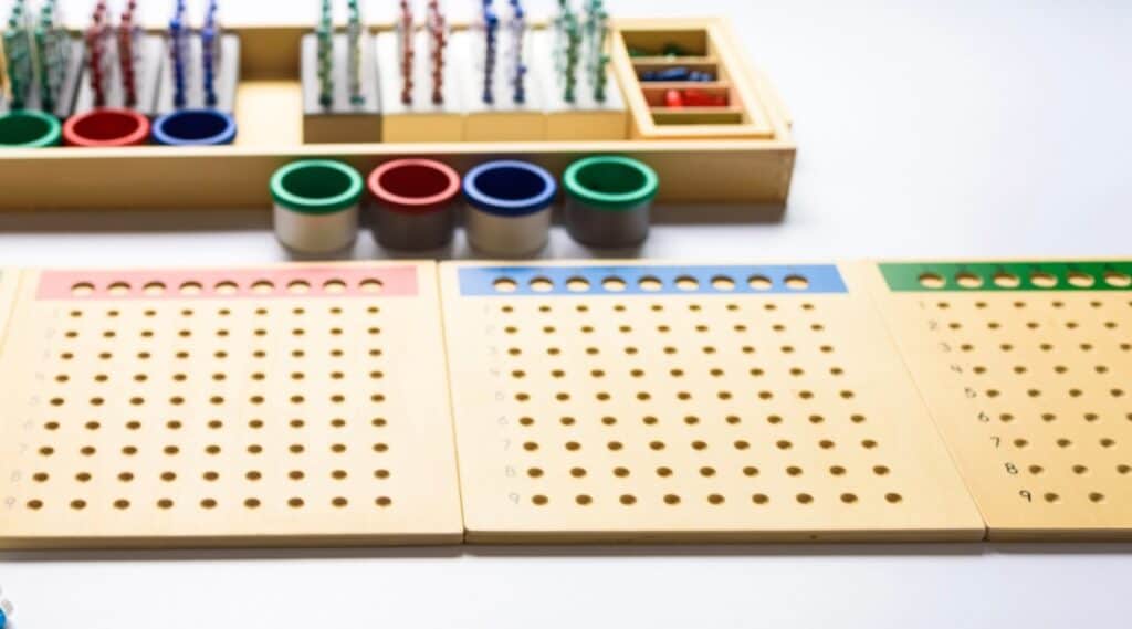 The Montessori long division material set up for a triple digit divisor.