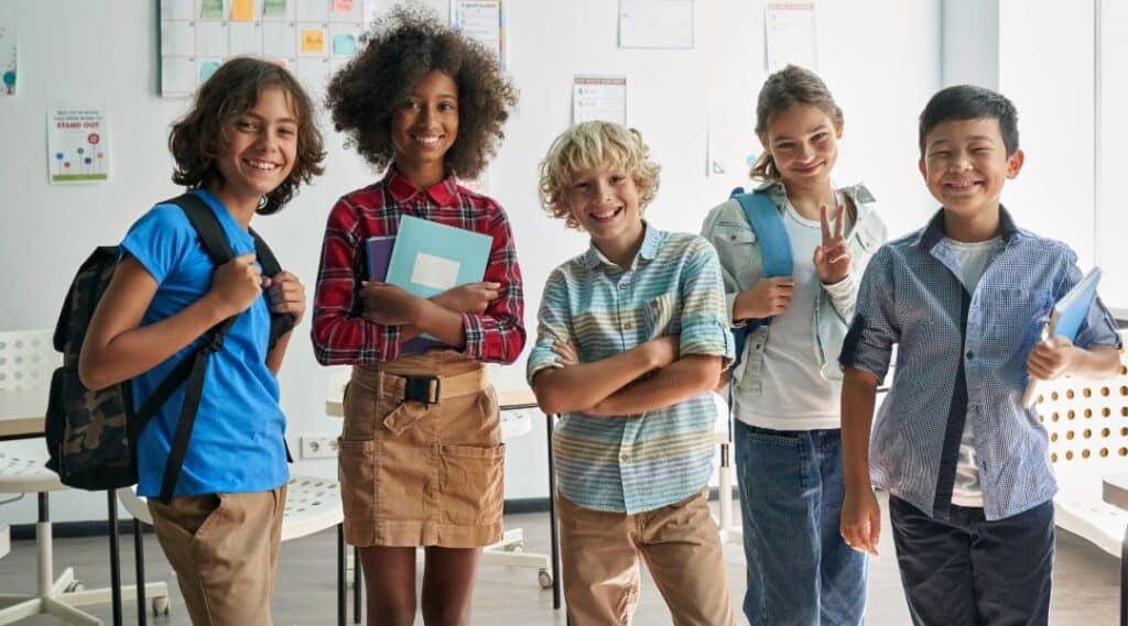 A group of 5 upper elementary students ranging in age from 9 to 12 years old. Another difference between Montessori vs traditional school is the mixed age groupings in classrooms.