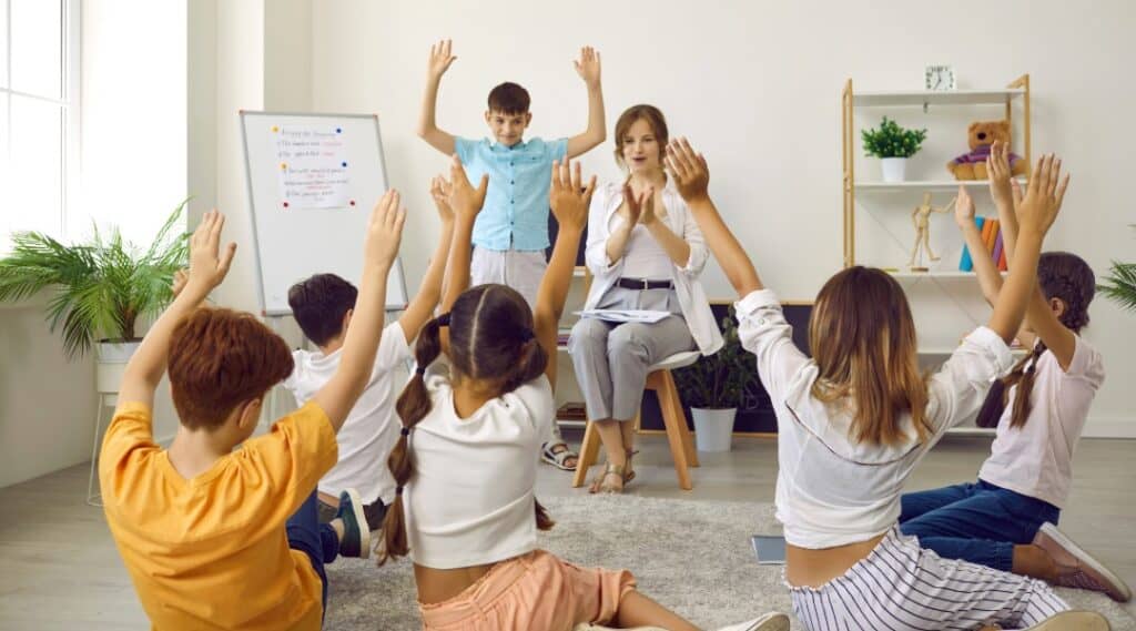 A teacher and small group of upper elementary students using a game in the classroom to spark creativity.