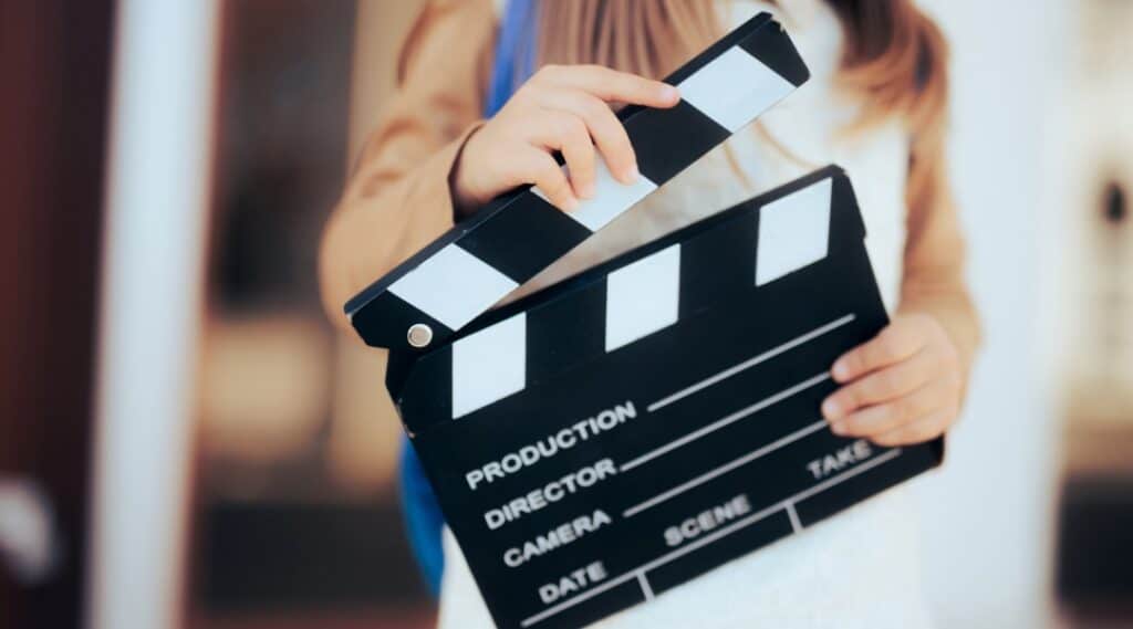 A film clapper being held by a student who is filming super bowl commercials.