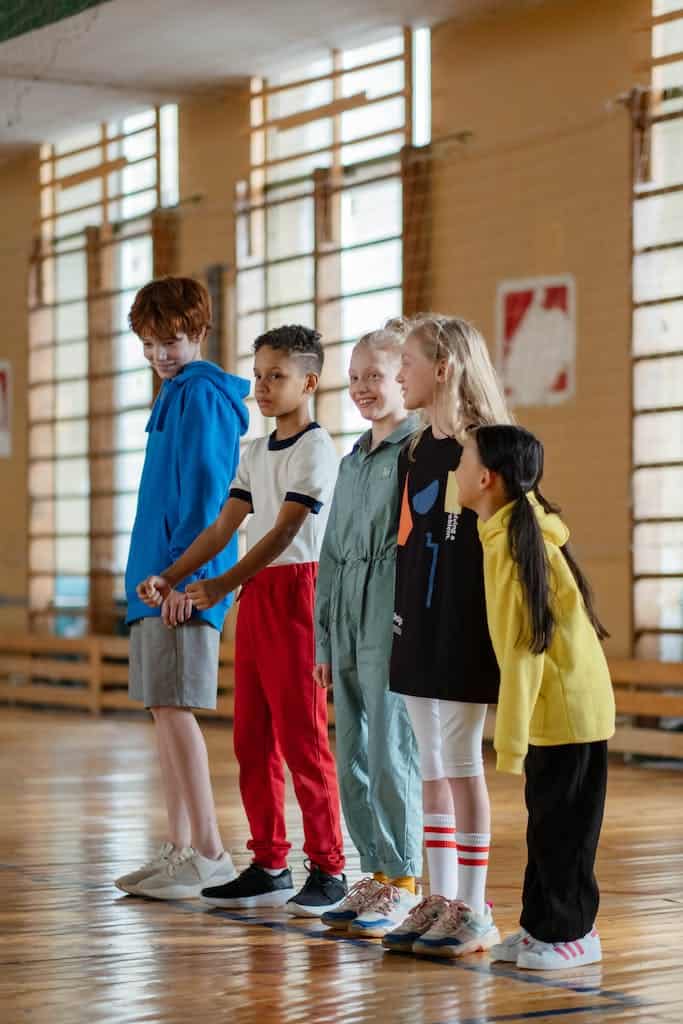 School Kids Line Up at the Gym waiting to practice their touchdown dance for a Super Bowl classroom activity