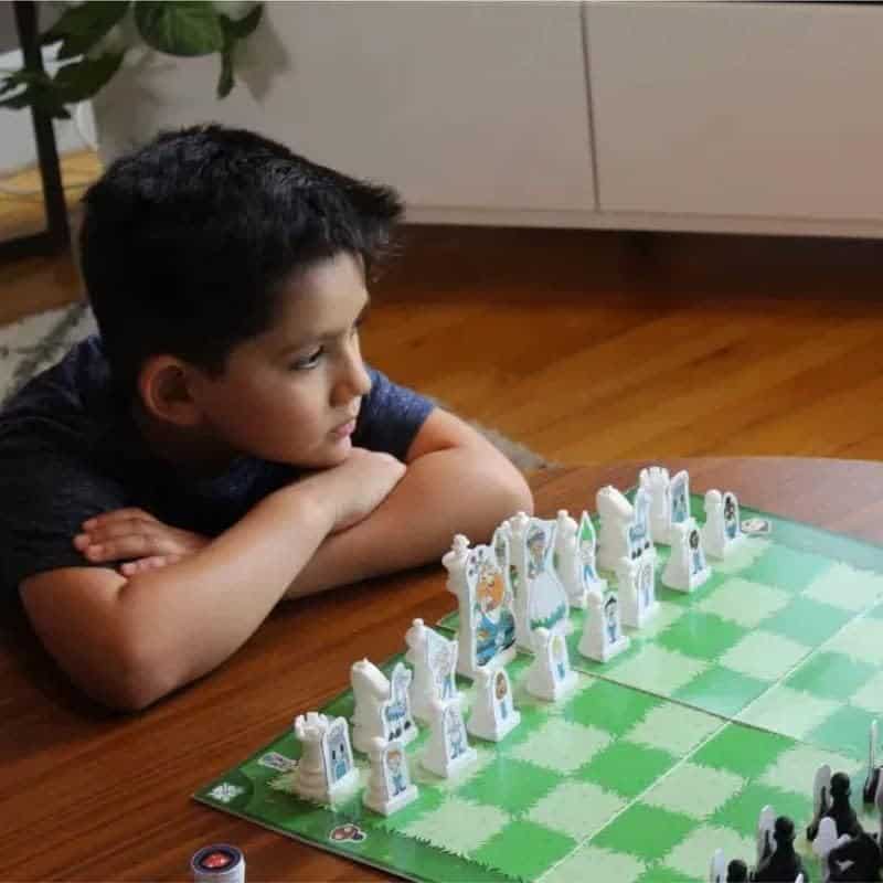 A young boy engaged in one of his favourite spring break activities for kids - chess!