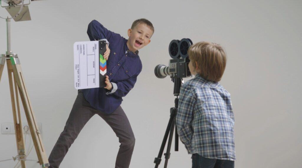 Two young boys getting ready to film an interview with the main character of their story.
