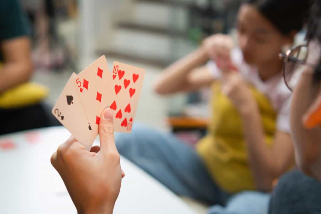 Elementary-aged kids playing math games with a deck of cards.