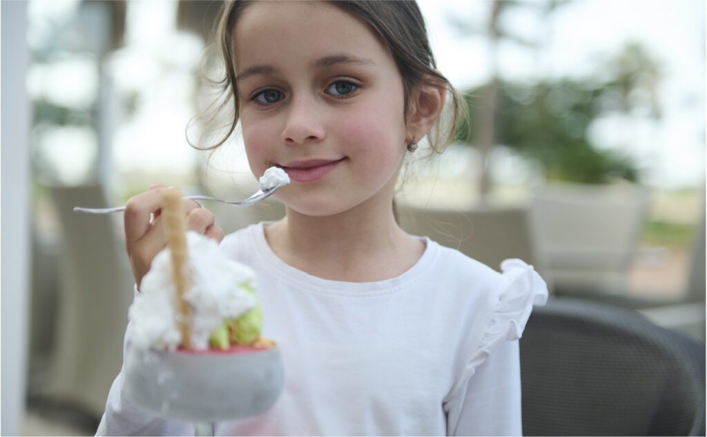 An image of a 12 year old girl having a meal at a restaurant.