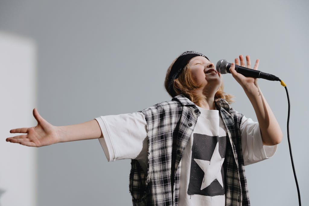 Energetic child singing karaoke into a microphone, expressing passion.
