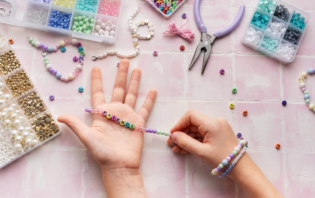 Kid creating handmade jewelry, enjoying a relaxing hobby