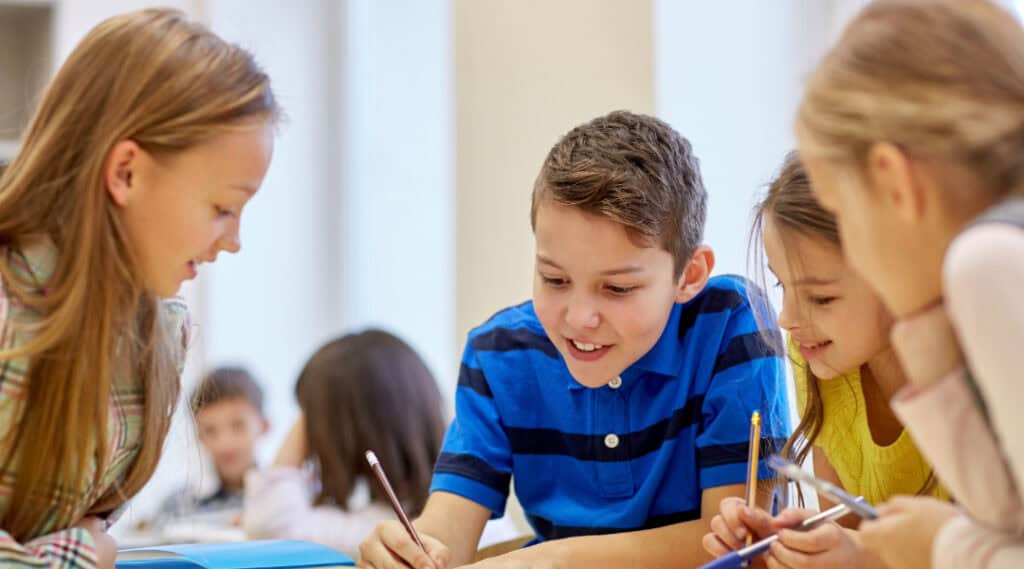 A small group of students working together in a Montessori elementary classroom.