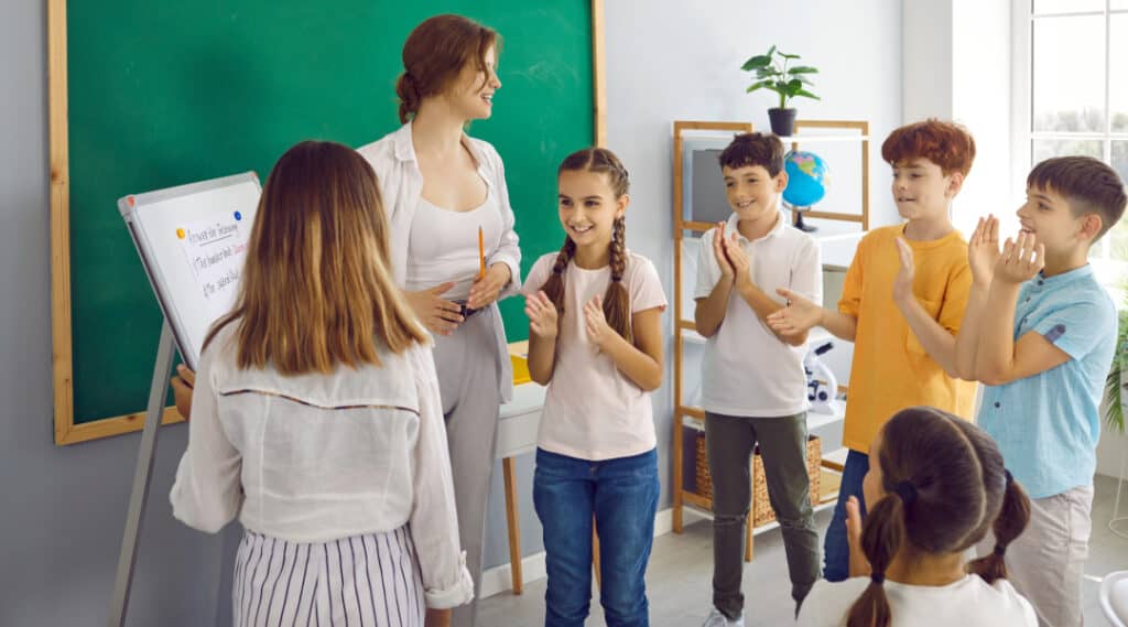A teacher and some students excited to chat about what they found on their alphabet scavenger hunt.