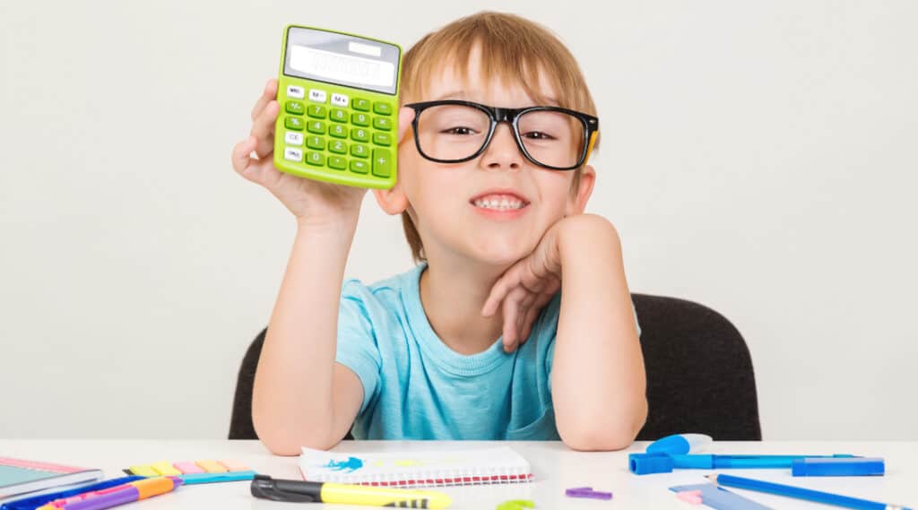 Cute kid with glasses holding a calculator.