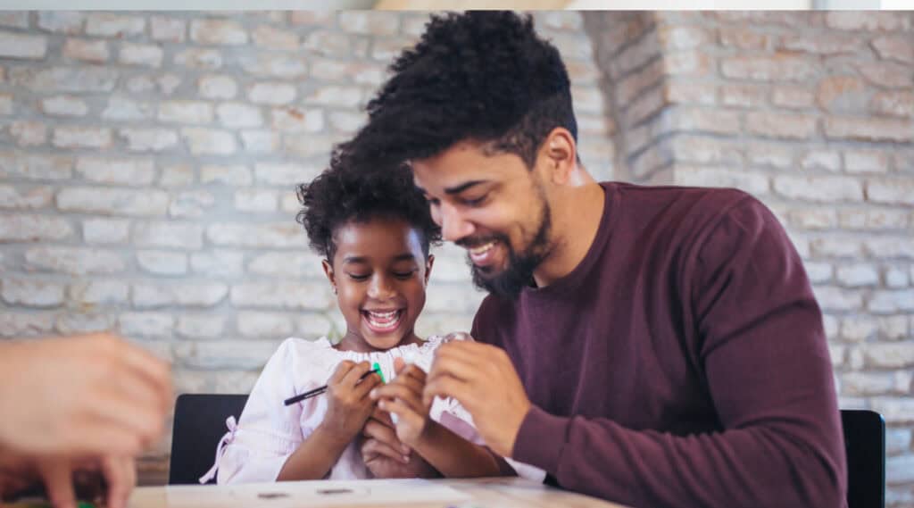 A father and daughter having fun with a summer math activity.