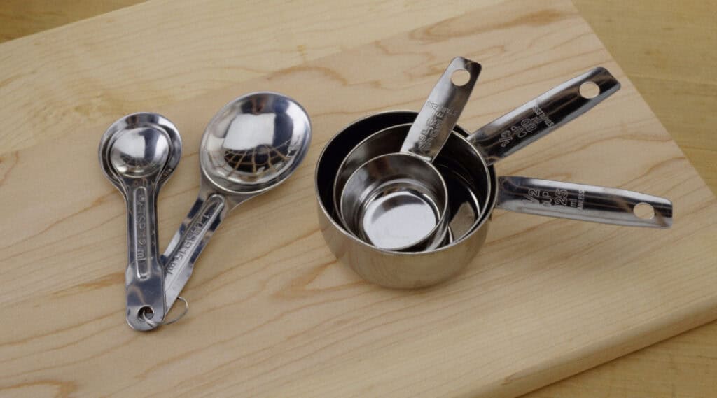 Measuring cups on a table. The perfect math lesson for summer learning.