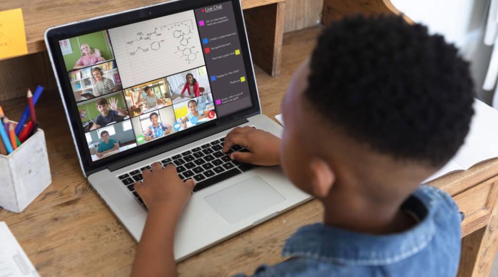 A young boy enjoying an Outschool online course.