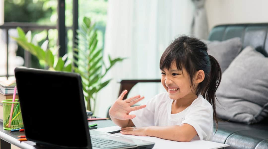 A young girl excited about her Outschool class.