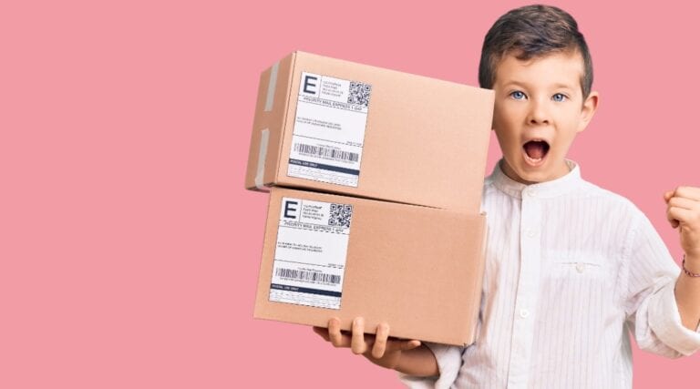 A. picture of a 10 year old boy holding two packages. He has an excited look on his face because he knows these are his monthly subscription boxes.