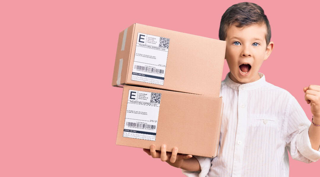 A. picture of a 10 year old boy holding two packages. He has an excited look on his face because he knows these are his monthly subscription boxes.