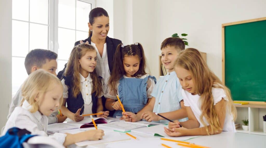 A group of students with their teacher having fun with story prompt dice.