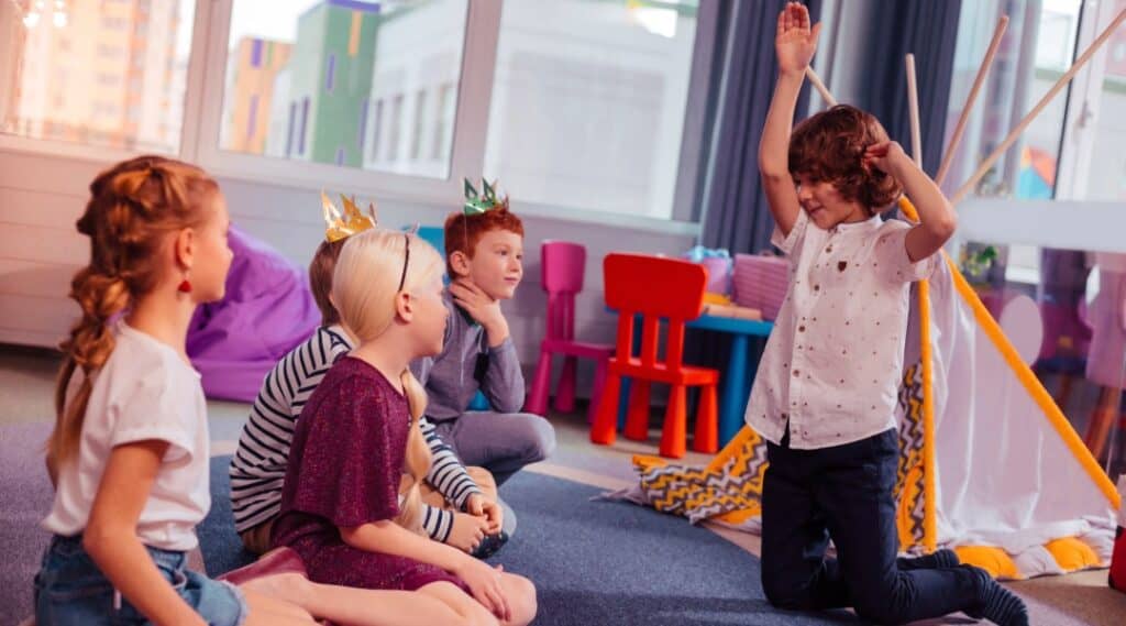 A group of elementary students playing charades.