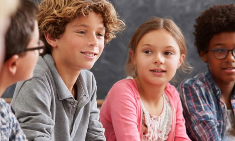 A group of upper elementary students engaging in a debate style grammar game.