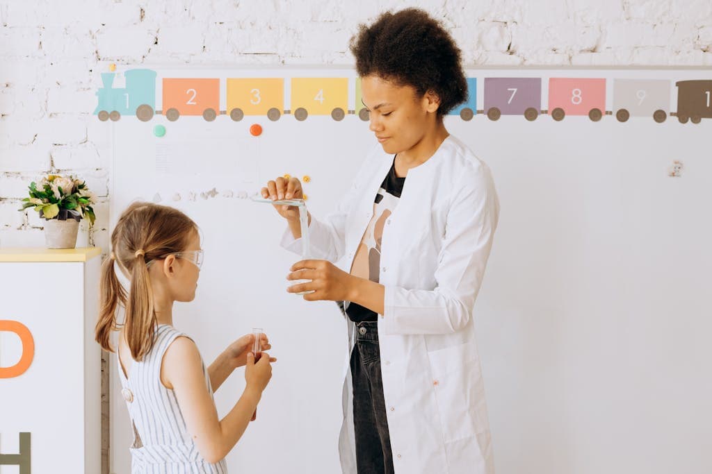 A teacher guides a child through a fun and educationalteachable moment in a classroom setting.