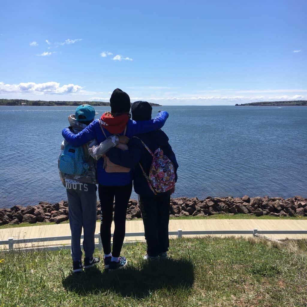 A picture of 3 grade 6 girls on a nature walk to learn.