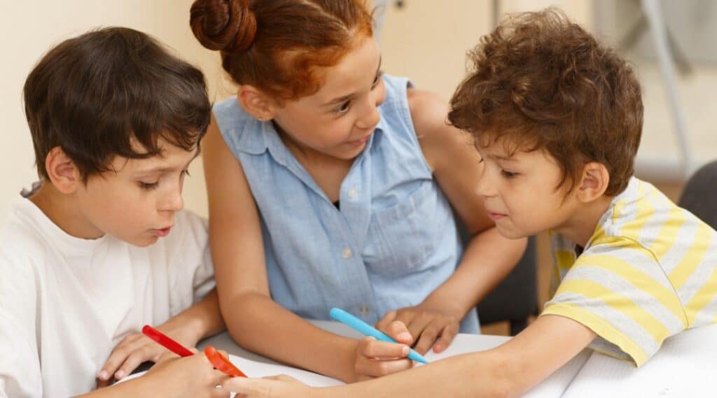 Group of elementary students working together and smiling during a classroom activity.